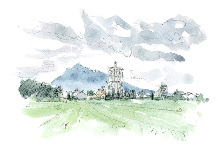 前方の板柳町の上空に沸き上がる雲。手前の高い塔は家畜のカントリーか?